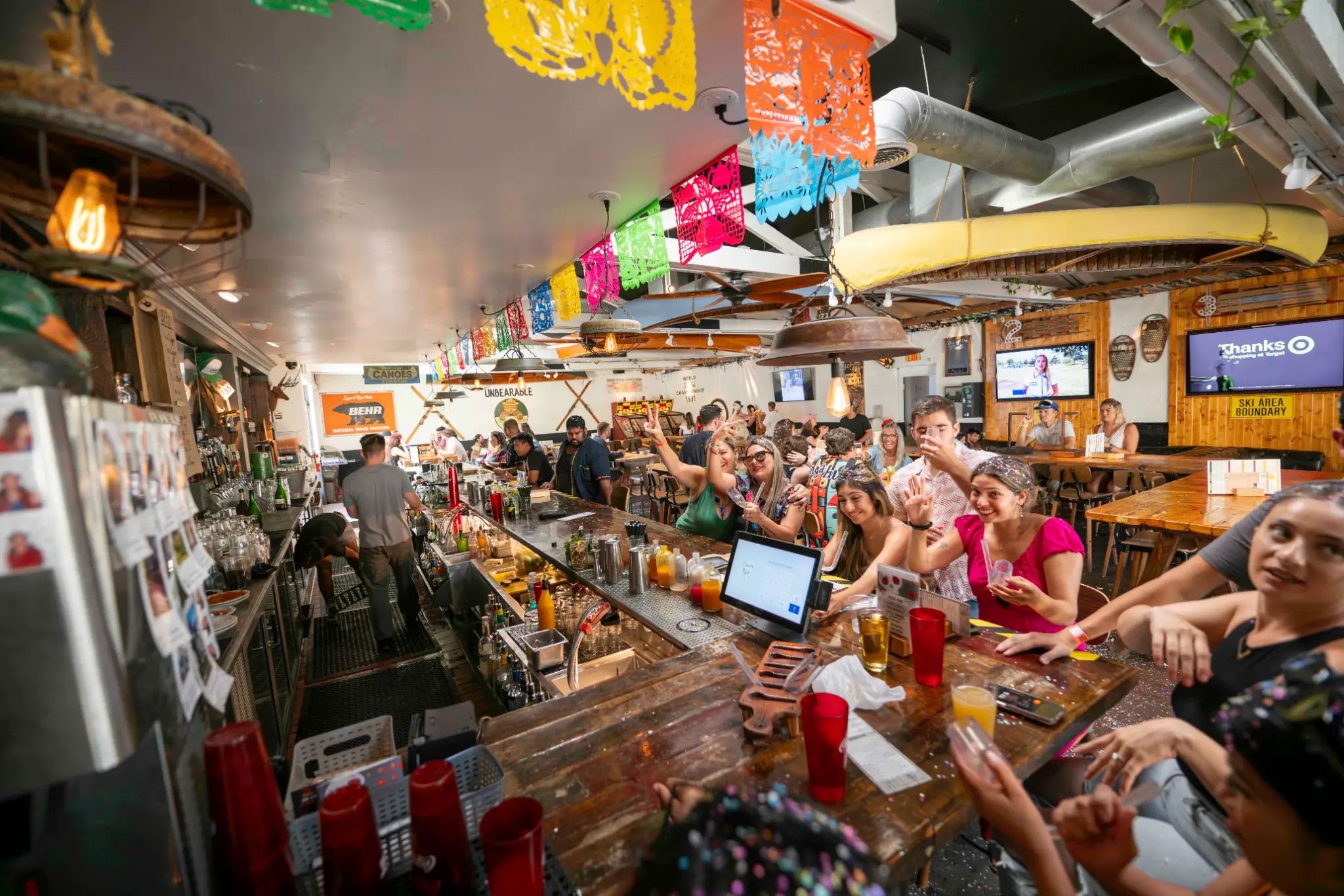 Packed full bar at Unbearable Skee Lodge during a fiesta-themed event showing full venue capacity