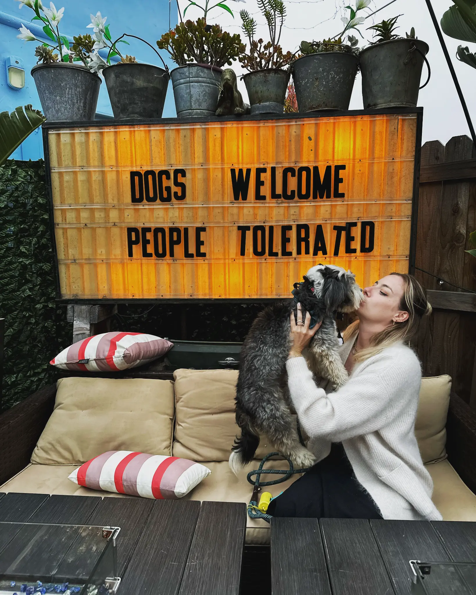 Dogs Welcome People Tolerated sign on the Wine Therapy back patio at Unbearable, Santa Barbara